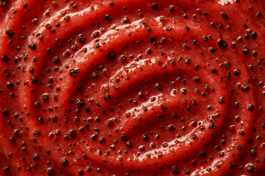 give me a close up swatch of a body scrub red with coffee ground in it 